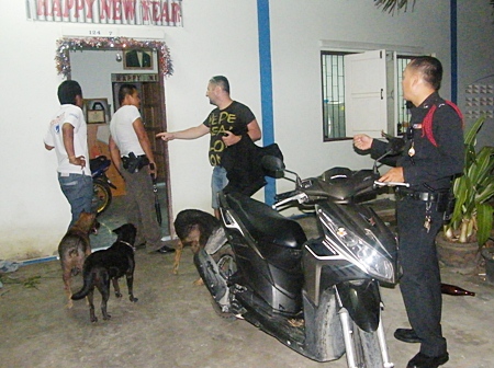 Police, with weapons drawn, search the house, but no one was home.